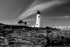Wood Island Lighthouse Above Rocky Shore in Maine - BW
